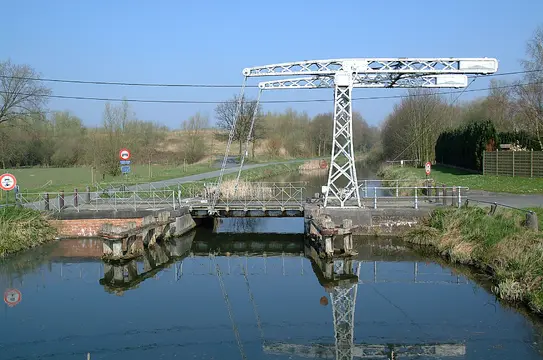 Sluis met metalen hefconstructie en brug over het kanaal